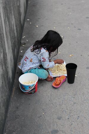 Editorial: Young Girl Begging on Concrete Walkway Over Motorway Interchange, Rangsit, Pathumthani, North Bangkok, 19th October 2013.のeditorial素材