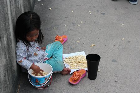 Editorial: Young Girl Begging on Concrete Walkway Over Motorway Interchange, Rangsit, Pathumthani, North Bangkok, 19th October 2013.のeditorial素材
