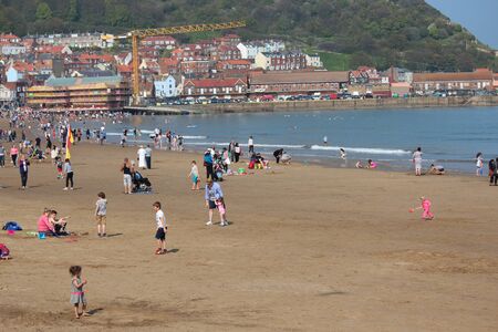 Editorial: Crowds of British Holidaymakers Flock to the Seaside and Choose Scarborough Beach on the Hottest Day of the Year; Sunday 8th May 2016.のeditorial素材
