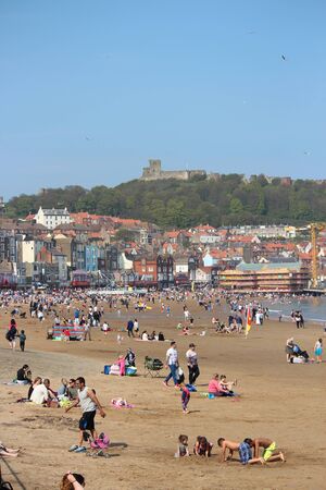 Editorial: Crowds of British Holidaymakers Flock to the Seaside and Choose Scarborough Beach on the Hottest Day of the Year; Sunday 8th May 2016.のeditorial素材