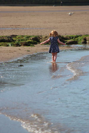 SCARBOROUGH, YORKSHIRE, ENGLAND: JUNE 25TH 2016; Children Playing on the Beach in Glorious Sunshine, Taking Advantage of the Change in the English Weather.のeditorial素材