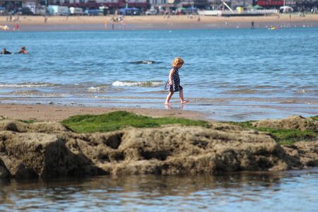 SCARBOROUGH, YORKSHIRE, ENGLAND: JUNE 25TH 2016; Children Playing on the Beach in Glorious Sunshine, Taking Advantage of the Change in the English Weather.のeditorial素材