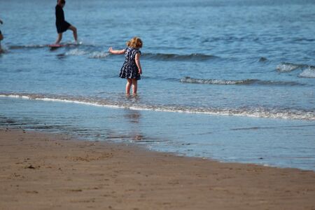 SCARBOROUGH, YORKSHIRE, ENGLAND: JUNE 25TH 2016; Children Playing on the Beach in Glorious Sunshine, Taking Advantage of the Change in the English Weather.のeditorial素材