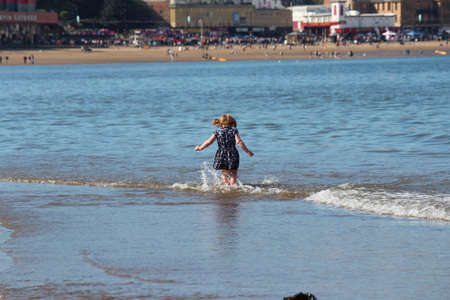 SCARBOROUGH, YORKSHIRE, ENGLAND: JUNE 25TH 2016:Children Playing on the Beach in Glorious Sunshine, Taking Advantage of the Change in English Weather.のeditorial素材