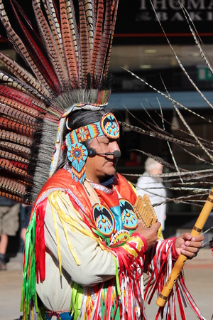 South American Indian Musicians in Traditional Costume Playing Panpipes.