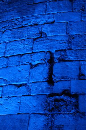 Blue Floodlit Medieval Stone Wall.