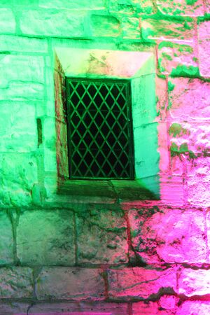 Rainbow Floodlighting on Medieval Stone Building.の写真素材