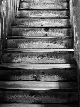Old worn wooden staircase in monochroomeの写真素材