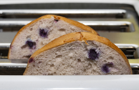 A sliced blueberry bagel ready for toasting.