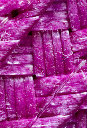 Extreme closeup of magenta colored woven placemat.の写真素材