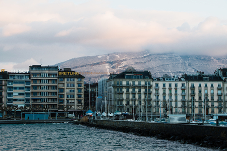 Picture taken on a cold day in March with the Bise wind blowing. Lake with waves. You can see the parked boats that owners take off the lake for the winterの写真素材