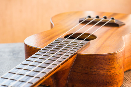 Close up of ukulele on table