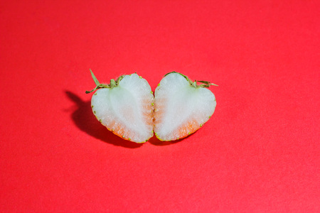Half of strawberries close up on red paperの写真素材