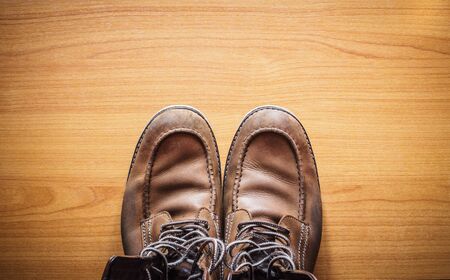 Brown leather shoes on wooden, top viewの写真素材