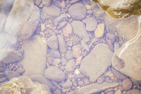 Stones and water surface in the riversideの写真素材