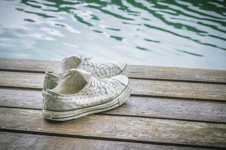 Sneaker on wooden with water surface backgroundの写真素材