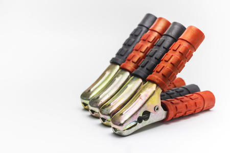Metal spring clamps with red and black plastic on handles on white background.の写真素材