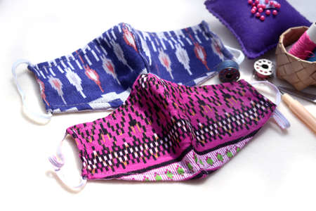 DIY handmade craft protective mask made of cotton fabric with blue and pink colors. Concept for...