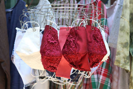 Lace fabric washable reusable fashion face masks hanging on clothes hanger. Making DIY cloth mask to prevent the outbreak of the Covid-19 virus has become a popular fashion throughout Thailand.の写真素材