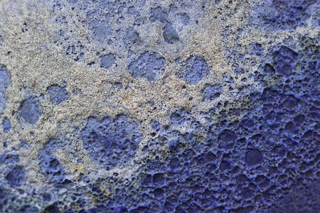 Close-up of the surface of a blue porous stone. Abstract background.