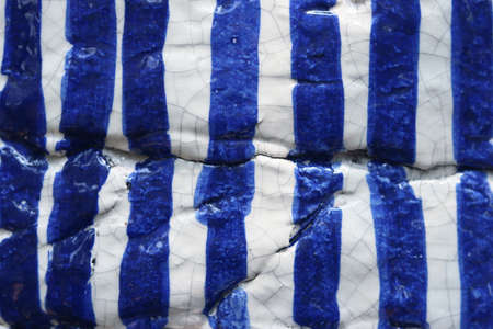 Blue and white patterned ceramic tile background. Close-up.