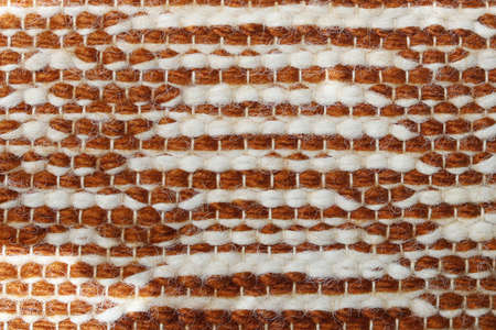 White and brown wool yarn cloth background. Surface of fabric texture in two tone colors.