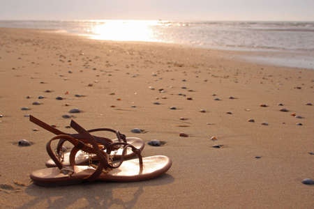 Sandals at the beach, evening atmosphereの写真素材