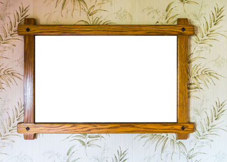 empty brown wooden picture frame hanging on a wall with decorated wallpaper backgroundの写真素材
