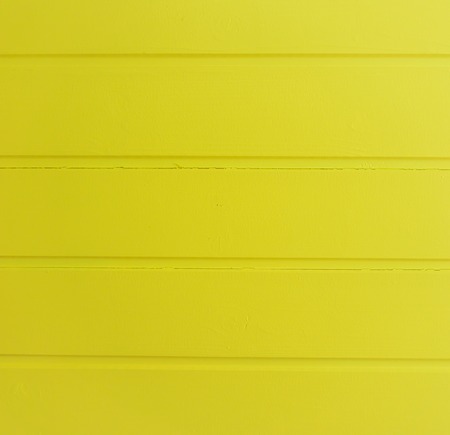 Modern bright yellow painted horizontal wooden planks structure background