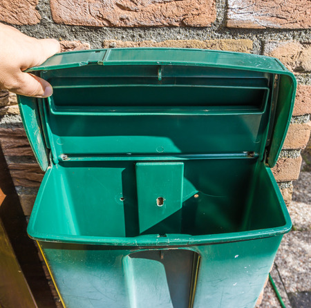 Empty open green plastic mailbox with nothing inside background textureの写真素材