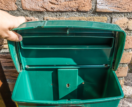Green empty open mailbox closeup with nothing inside background textureの写真素材