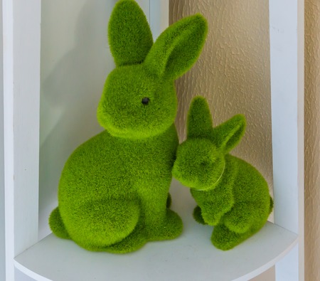 Easter baby bunny and mother bunny together on a shelf easter home decorationの写真素材