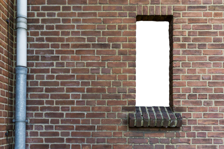 stone brick wall with a cut out open empty window isolated with white texture backgroundの写真素材