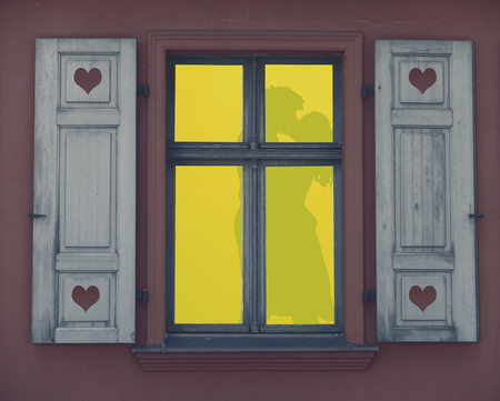 silhouette of a couple making love in a lighted window frame, a romantic night, valentines day...