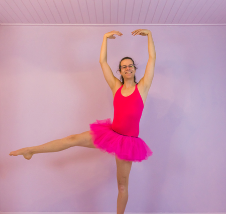 funny young transgender girl performing a developpe, classical ballet dancing moves, LGBT in the dance sportの写真素材