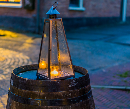 lighted candle in a glass pyramid, city light decorationsの写真素材