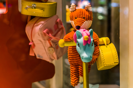 Diverse cute children toys, stuffed animal, unicorn scooter and some school bagsの写真素材