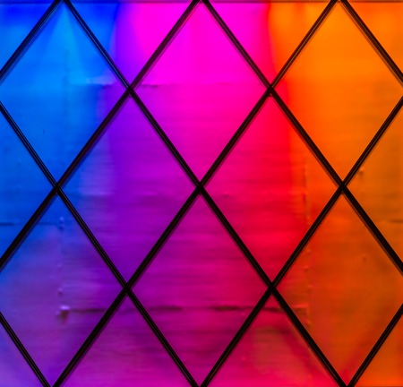 Modern and colorful lights in the colors blue,purple, pink, red and orange. Diamond pattern, Neon light backgroundの写真素材