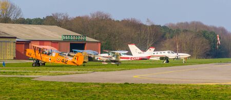 parked stunt airplanes at seppe airport breda, Bosschenhoofd, north brabant, The Netherlands, popular recreational aviation, group of skydivers waiting for take off at seppe airport Breda, Bosschenhoofd, The netherlands, ENPC skydive, March 30, 2019のeditorial素材