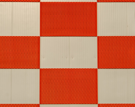 red and white checkered pattern on a metal wall, architecture backgroundの写真素材