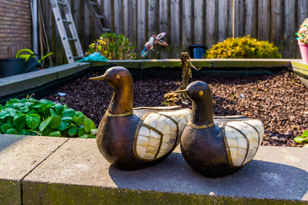 wooden duck statuettes with decorated wings, bird sculptures for the garden, backyard decorationsの写真素材