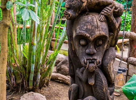 evil looking african carved wooden sculpture, traditional garden decorations
