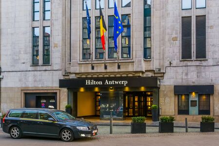 Antwerpen, Belgium, April 23, 2019, The entrance of the Hilton Hotel in Antwerp city with a taxi car waiting in front of the doorのeditorial素材