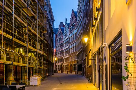 road of a lighted city alley in antwerp city by night, Belgian architecture and street scenery, Antwerpen, Belgium, April 23, 2019のeditorial素材