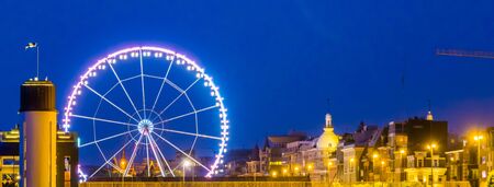 skyline of antwerp city with the ferris wheel lighted at night, Antwerpen, Belgiumの写真素材