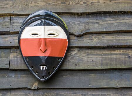 classical african mask on a wooden wall background, Culture in Africa, traditional backgroundの写真素材