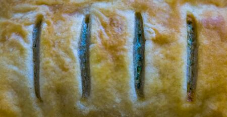 macro closeup of a french puff pastry filled with spinach, traditional foodsの写真素材