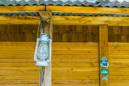 Vintage miner lantern hanging at a beach hut, nostalgic lightingの写真素材