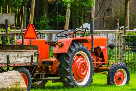 Red tractor with a trailer, Agricultural transport and equipment, Farm machineryの写真素材