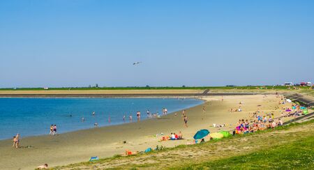 Bergse diepsluis with holiday tourists during summer season, Popular Beach in tholen, Zeeland, oesterdam, The netherlands, 22 april, 2019のeditorial素材